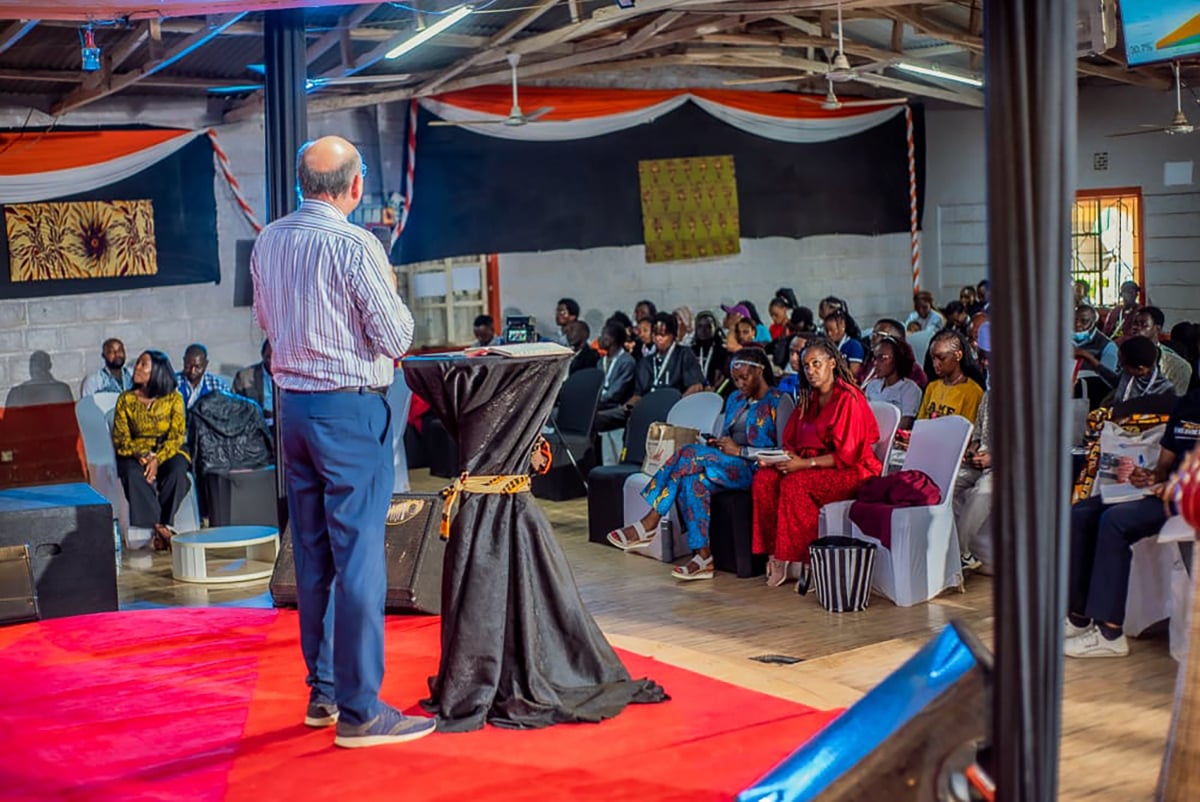 Speaker addressing attendees during a Mission Momentum Africa conference session.
